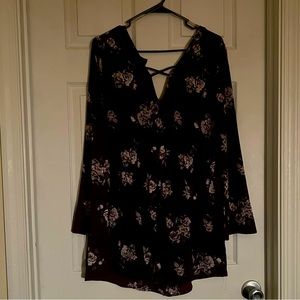 Maroon romper with lavender flowers on it.